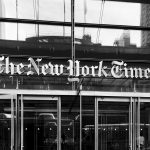 Grayscale image of The New York Times building entrance in New York City. — Best Antivirus Designed for Android