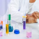 A scientist's hand working with colorful liquids in a laboratory setting. — Latent Dirichlet Allocation: Probabilistic Topic