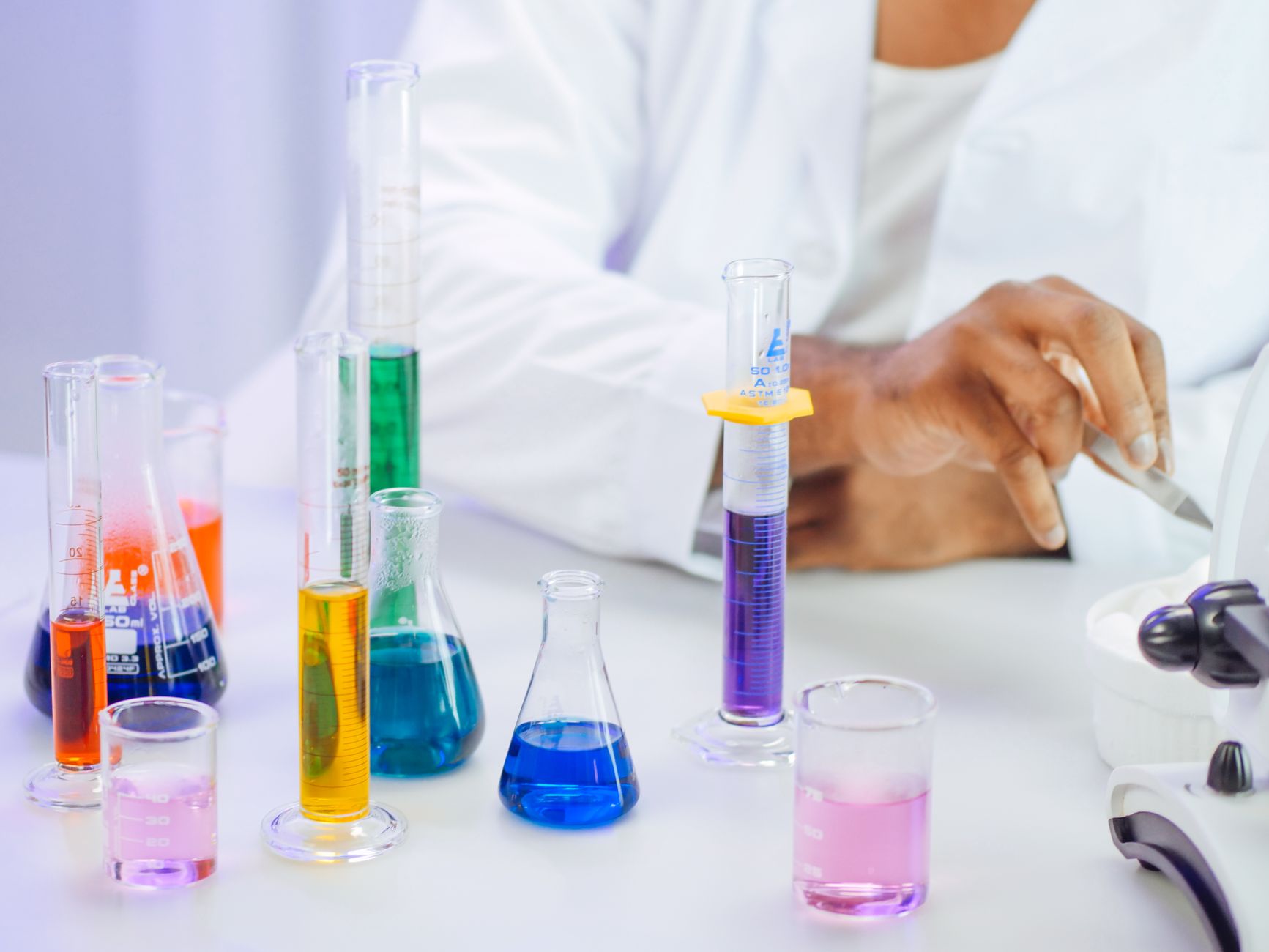A scientist's hand working with colorful liquids in a laboratory setting. — Latent Dirichlet Allocation: Probabilistic Topic